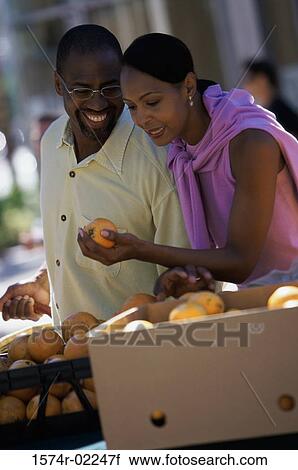 Young couple shopping in the market View Large Photo Image Stock Image - Young couple shopping in the market. Fotosearch