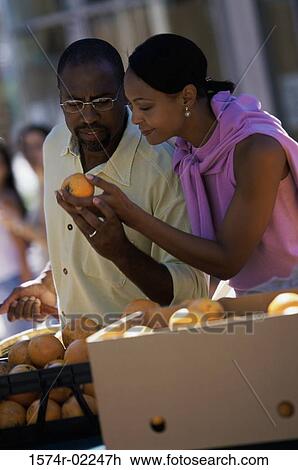 Young couple shopping in the market View Large Photo Image Stock Image - Young couple shopping in the market. Fotosearch