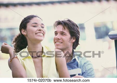 Stock Image - Young couple smiling. Fotosearch