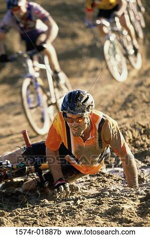 Young man falling from a bicycle in a race View Large Photo Image Stock Image - Young man falling from a bicycle in a race. Fotosearch