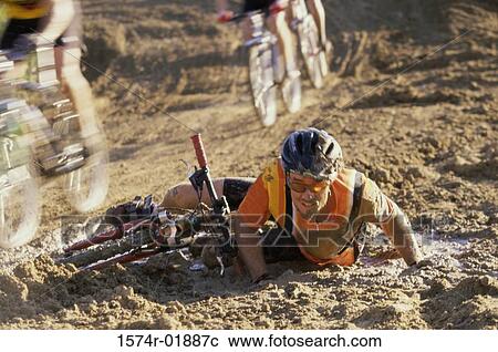 Stock Image - Young man falling from a bicycle in a race. Fotosearch