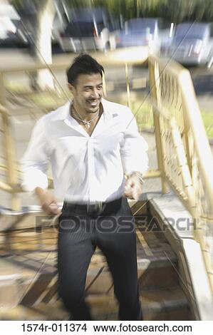Young man walking down a staircase View Large Photo Image Picture - Young man walking down a staircase. Fotosearch