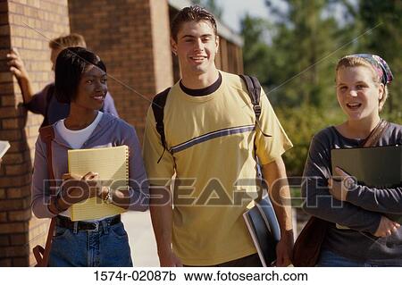 Young man walking with two young women View Large Photo Image Stock Image - Young man walking with two young women. Fotosearch