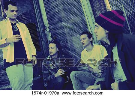 Young men and women sitting together View Large Photo Image Stock Image - Young men and women sitting together. Fotosearch