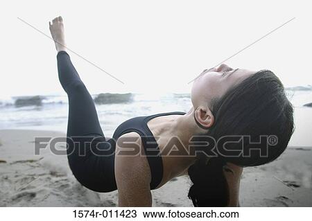 Young woman exercising on the beach View Large Photo Image Stock Image - Young woman exercising on the beach. Fotosearch