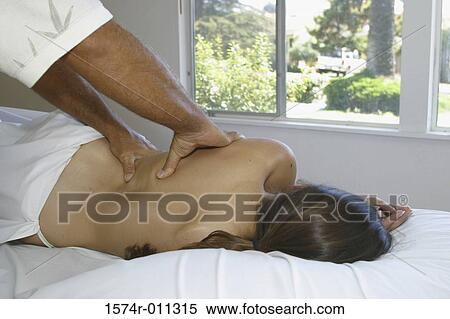 Stock Photography - Young woman getting a back massage. Fotosearch