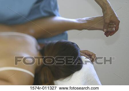 Stock Photo - Young woman getting a foot massage. Fotosearch