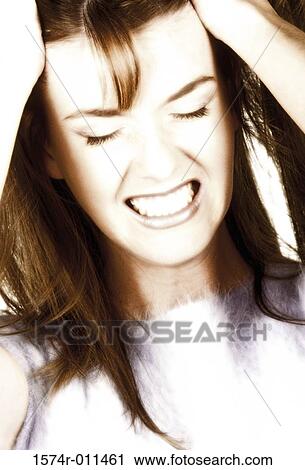 Young woman holding her head View Large Photo Image Stock Image - Young woman holding her head. Fotosearch