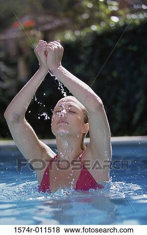 Young woman in a swimming pool View Large Photo Image Stock Photo - Young woman in a swimming pool. Fotosearch
