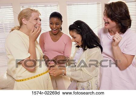 Young woman measuring a pregnant woman's abdomen View Large Photo Image Stock Image - Young woman measuring a pregnant woman's abdomen. Fotosearch