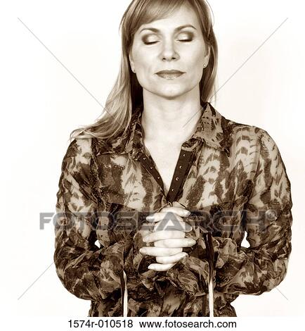 Young woman praying View Large Photo Image Stock Photo - Young woman praying. Fotosearch