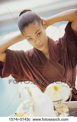 Young woman wearing a bathrobe View Large Photo Image Stock Image - Young woman wearing a bathrobe. Fotosearch