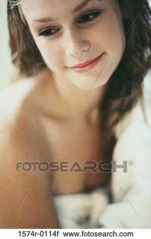 Young woman wrapped in a towel smiling View Large Photo Image Stock Image - Young woman wrapped in a towel smiling. Fotosearch