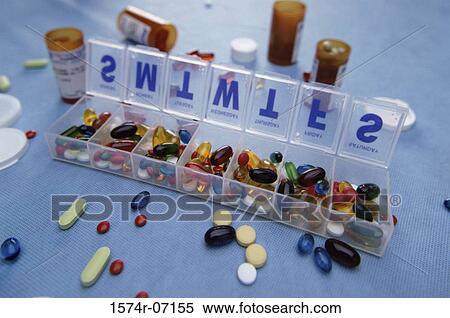Stock Photography - Assortment of tablets and capsules in a pill box and vials. Fotosearch