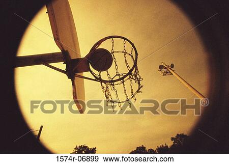 Stock Photo - Basketball falling through a hoop. Fotosearch