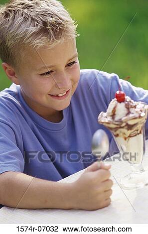 Boy looking at ice cream sundae View Large Photo Image Stock Image - Boy looking at ice cream sundae. Fotosearch