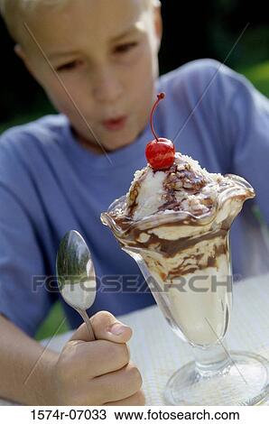 Boy looking at ice cream sundae View Large Photo Image Stock Image - Boy looking at ice cream sundae. Fotosearch