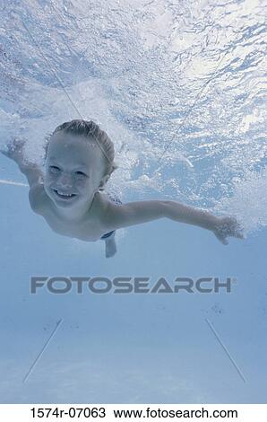 Boy swimming underwater in a swimming pool View Large Photo Image Stock Image - Boy swimming underwater in a swimming pool. Fotosearch