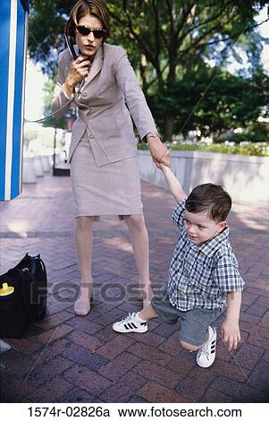 Boy tugging his mother by her hand View Large Photo Image Stock Image - Boy tugging his mother by her hand. Fotosearch