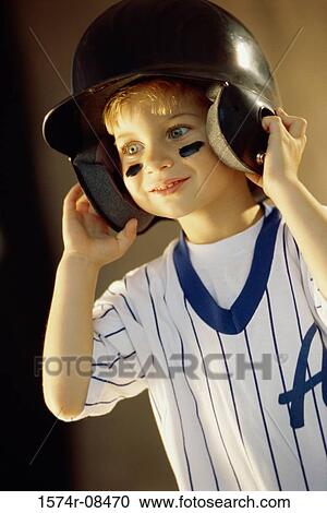 Stock Image - Boy wearing a baseball helmet. Fotosearch
