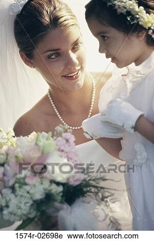 Bride and a flower girl talking to each other View Large Photo Image Stock Image - Bride and a flower girl talking to each other. Fotosearch
