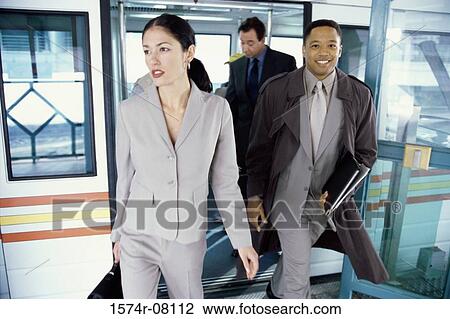 Business executives exiting a subway train smiling View Large Photo Image Stock Image - Business executives exiting a subway train smiling. Fotosearch