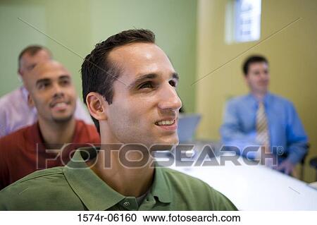 Stock Image - Business executives in a conference room. Fotosearch