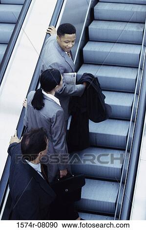 Business executives on an escalator View Large Photo Image Stock Image - Business executives on an escalator. Fotosearch
