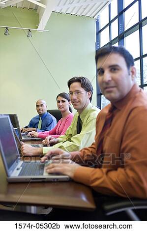 Business executives sitting in a conference room View Large Photo Image Stock Image - Business executives sitting in a conference room. Fotosearch