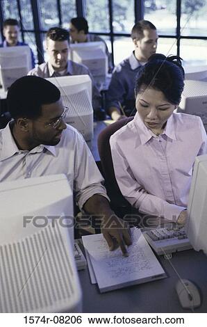 Business executives sitting in front of computer monitors View Large Photo Image Stock Photograph - Business executives sitting in front of computer monitors. Fotosearch