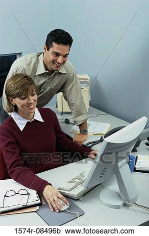 Businessman and a businesswoman in an office View Large Photo Image Stock Image - Businessman and a businesswoman in an office. Fotosearch
