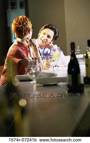 Businessman and a businesswoman sitting in a restaurant View Large Photo Image Stock Image - Businessman and a businesswoman sitting in a restaurant. Fotosearch
