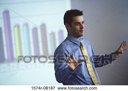 Businessman giving a presentation in an office View Large Photo Image Stock Photo - Businessman giving a presentation in an office. Fotosearch