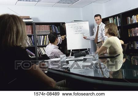 Businessman giving a presentation in an office View Large Photo Image Stock Photo - Businessman giving a presentation in an office. Fotosearch