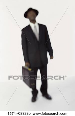 Businessman holding a briefcase View Large Photo Image Stock Image - Businessman holding a briefcase. Fotosearch
