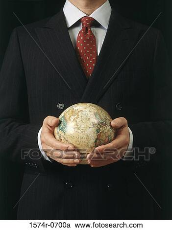 Stock Image - Businessman holding a globe. Fotosearch