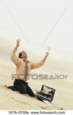 Businessman kneeling at a beach in front of an open briefcase View Large Photo Image Stock Image - Businessman kneeling at a beach in front of an open briefcase. Fotosearch