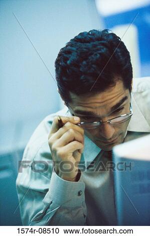 Stock Image - Businessman looking at a computer monitor. Fotosearch