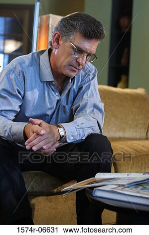 Businessman reading a magazine View Large Photo Image Stock Image - Businessman reading a magazine. Fotosearch