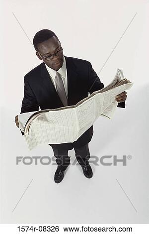 Businessman reading a newspaper View Large Photo Image Stock Photograph - Businessman reading a newspaper. Fotosearch