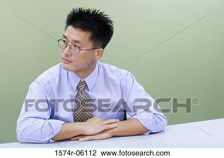 Businessman sitting in an office View Large Photo Image Stock Image - Businessman sitting in an office. Fotosearch