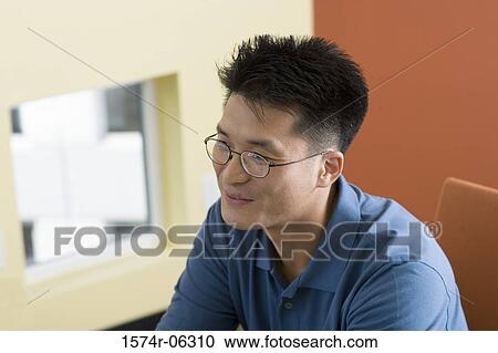 Businessman sitting in an office View Large Photo Image Stock Image - Businessman sitting in an office. Fotosearch