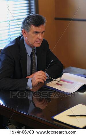 Businessman sitting in an office View Large Photo Image Stock Image - Businessman sitting in an office. Fotosearch