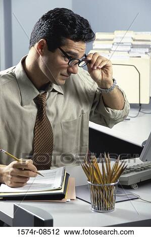Stock Image - Businessman sitting in an office. Fotosearch