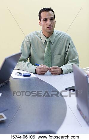 Businessman sitting in an office View Large Photo Image Stock Photography - Businessman sitting in an office. Fotosearch