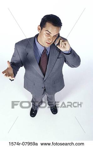 Businessman talking on a mobile phone View Large Photo Image Stock Image - Businessman talking on a mobile phone. Fotosearch