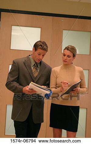 Businessman talking to a businesswoman View Large Photo Image Picture - Businessman talking to a businesswoman. Fotosearch