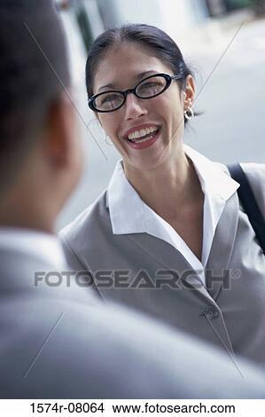 Businessman talking to a businesswoman View Large Photo Image Picture - Businessman talking to a businesswoman. Fotosearch