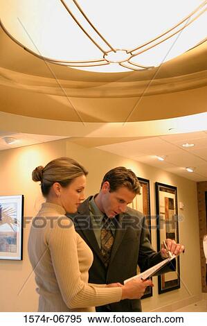 Stock Photography - Businessman talking to a businesswoman. Fotosearch