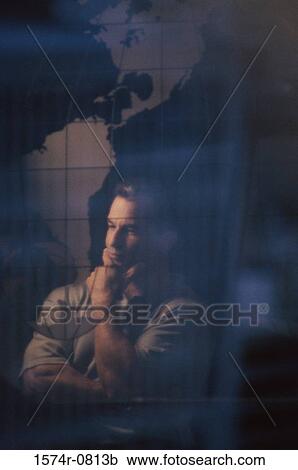 Businessman thinking standing near a world map View Large Photo Image Stock Image - Businessman thinking standing near a world map. Fotosearch